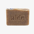 Bar of soap with 'aide' branding on a white background