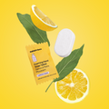 Foaming hand soap tablet with lemon slices and leaves on a yellow background