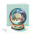 Greeting card with a snow globe design featuring a house and 'Let it Snow' text on a light blue background.