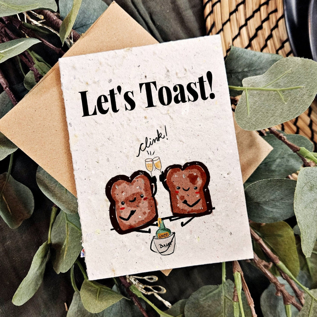 Greeting card with cartoon toast characters and 'Let's Toast!' text, surrounded by greenery.
