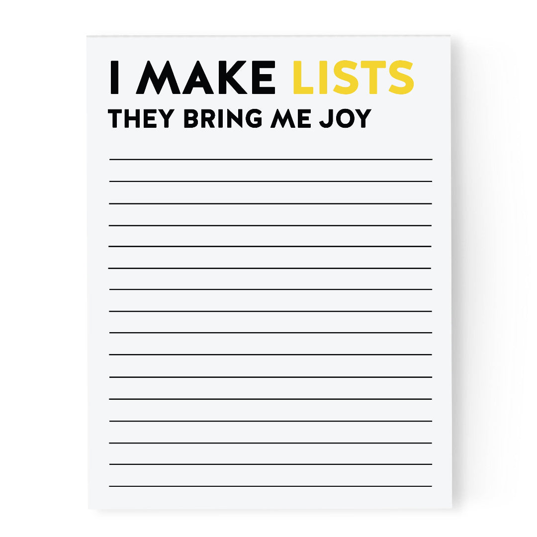 Notepad with text 'I MAKE LISTS THEY BRING ME JOY' and lined pages on a white background