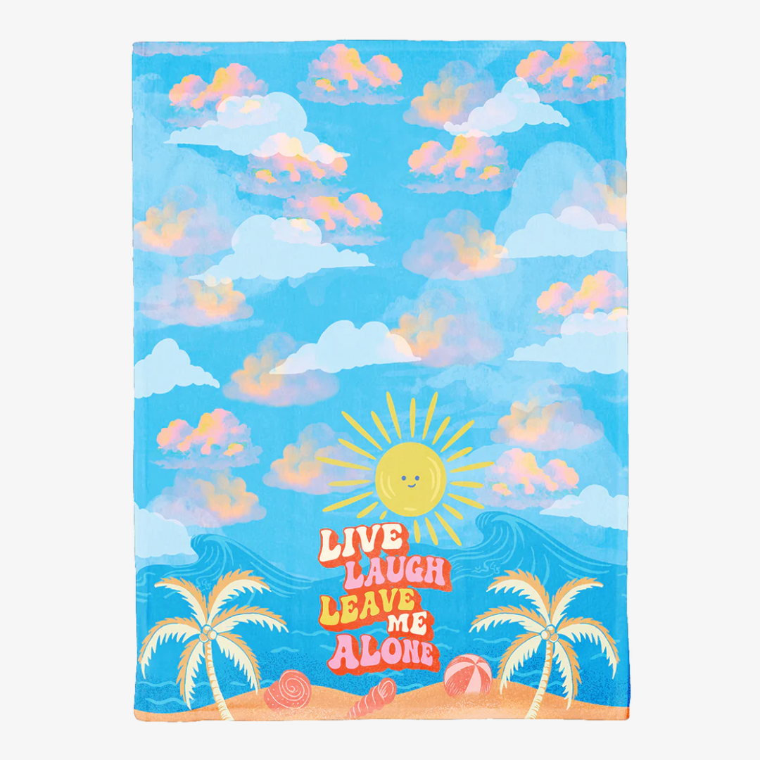 Towel with a tropical design featuring palm trees, sun, and clouds with 'Live Laugh Leave Me Alone' text.