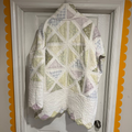Quilt with geometric pattern hanging on a door