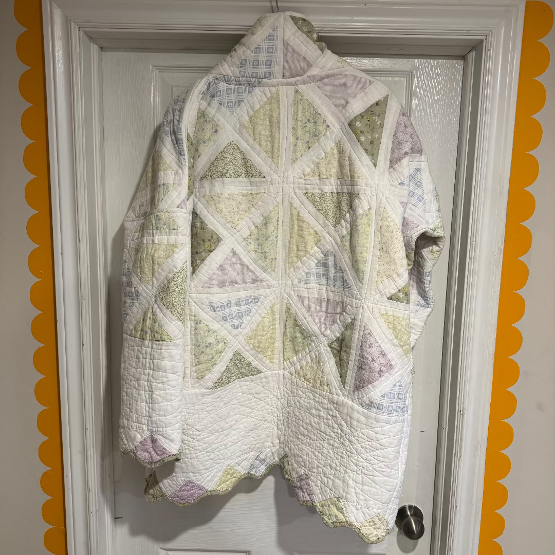 Quilt with geometric pattern hanging on a door