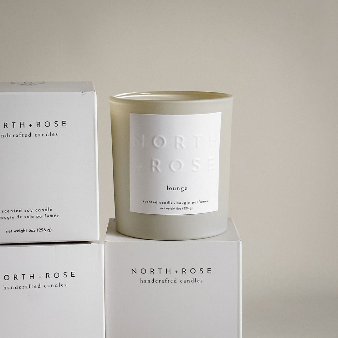 North + Rose scented candle and packaging on a light background