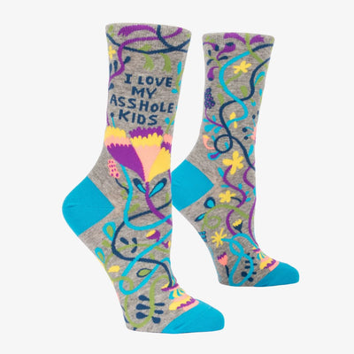 A pair of grey women's crew socks with vibrant, abstract floral and swirling line patterns in purple, yellow, pink, green, and blue. Text on one sock reads 