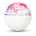 Bath bomb with a colorful top and white bottom on a white background