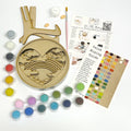 Painting kit with wooden heart-shaped mold, paint tubes, mixing guide, and color swatch on a white background.