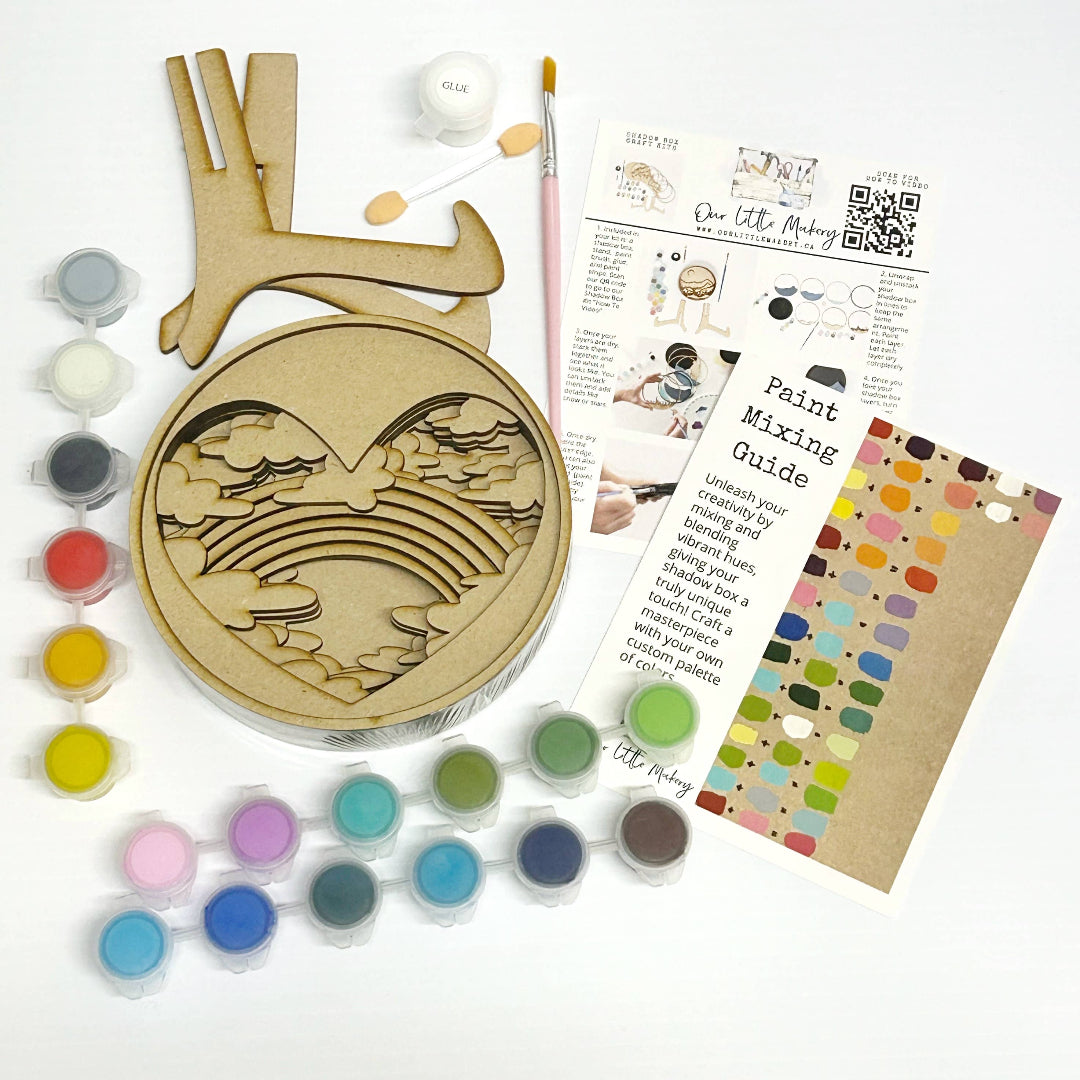 Painting kit with wooden heart-shaped mold, paint tubes, mixing guide, and color swatch on a white background.