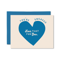 Engagement card with blue heart and text on beige card with blue envelope