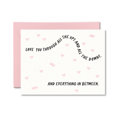 Greeting card with romantic message and pink hearts on a white background