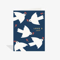 Card with white doves and 'Love & Joy' text on a blue background