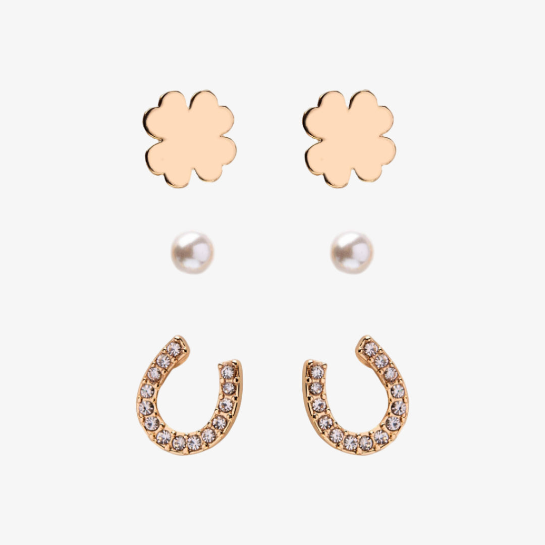 Set of gold flower and horseshoe earrings with pearl accents on a white background