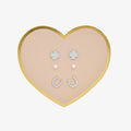 Heart-shaped jewelry box with earrings on a white background