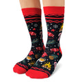 Christmas-themed socks with red cuffs and toes on a white background