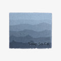 Bar of soap with gradient blue design and 'Soap So Co.' branding on a white background