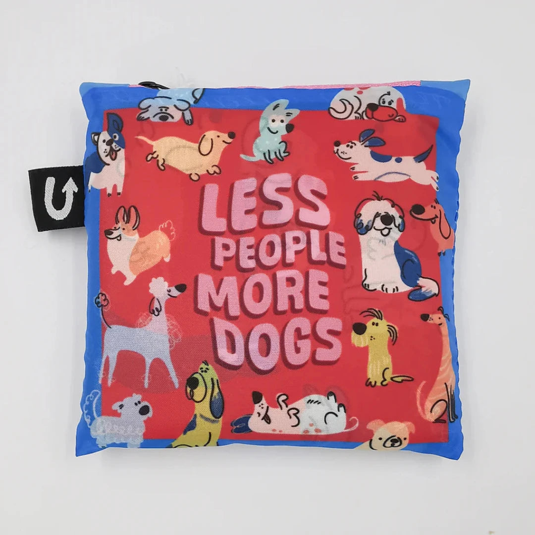 A colorful tote bag with a dog-themed design. The bag is covered in illustrations of various dog breeds in different poses, with the text "Less People More Dogs" printed in the center.