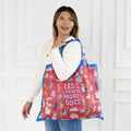A colorful tote bag with a dog-themed design. The bag is covered in illustrations of various dog breeds in different poses, with the text "Less People More Dogs" printed in the center.