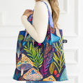 A colorful tote bag with a psychedelic mushroom and plant pattern. The bag has a dark blue background with bright, vibrant colors.