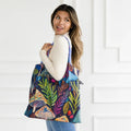 A colorful tote bag with a psychedelic mushroom and plant pattern. The bag has a dark blue background with bright, vibrant colors.