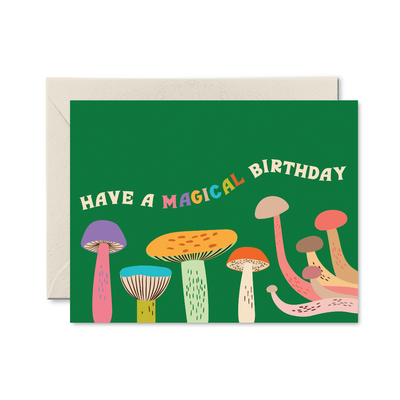 Greeting card with colorful mushrooms and 'Have a Magical Birthday' text on a green background