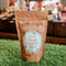 A brown paper bag filled with maple caramels. The bag has a label that says 