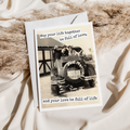 Greeting card with vintage car and couple photo, text 'May your life together be full of love' on a textured surface.