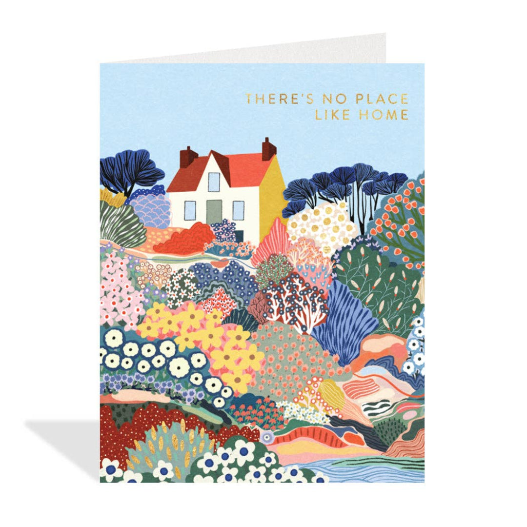 Colorful greeting card with a house and nature design, featuring the text 'There's no place like home'.