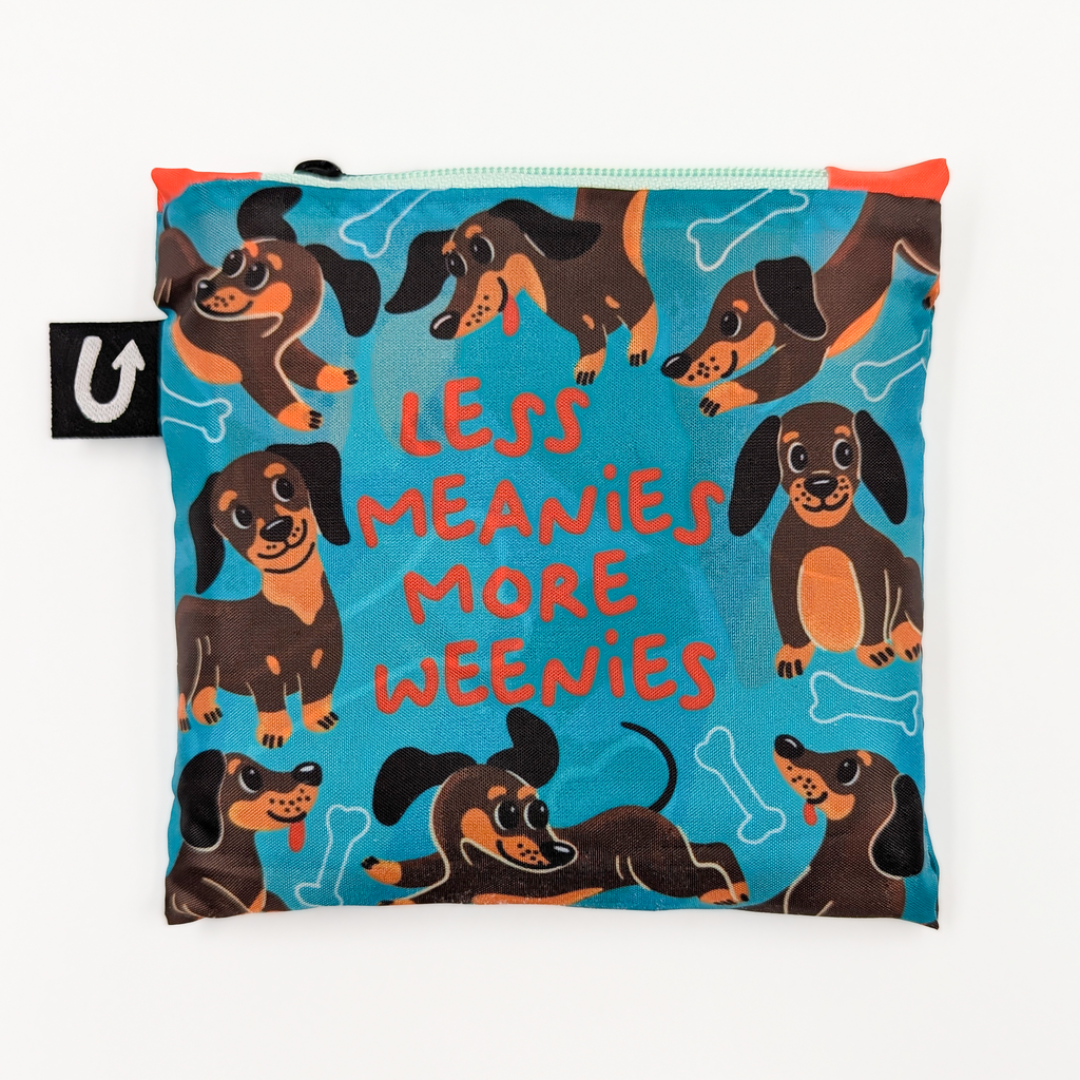 Reusable bag with dachshund pattern and text 'LESS MEANIES MORE WEENIES' on a blue background.
