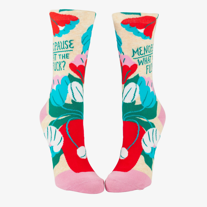 A pair of crew socks with a floral pattern and the phrase 