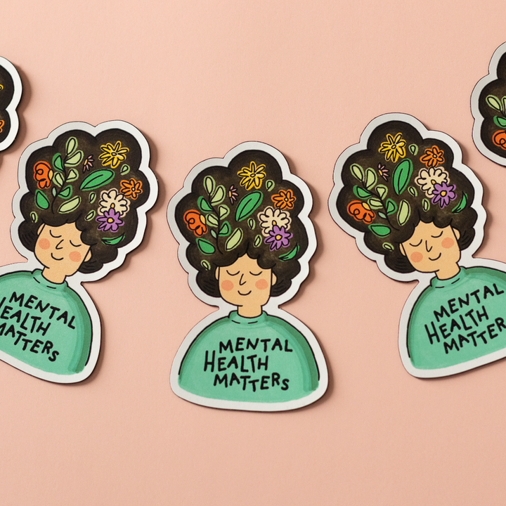 Mental Health Matters vinyl sticker is an illustration of a person with flowers in their big hair and the words 
