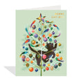 Greeting card with a colorful Christmas tree design featuring a bear and birds on a light green background.