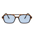 Sunglasses with tortoiseshell frame and blue lenses on a white background