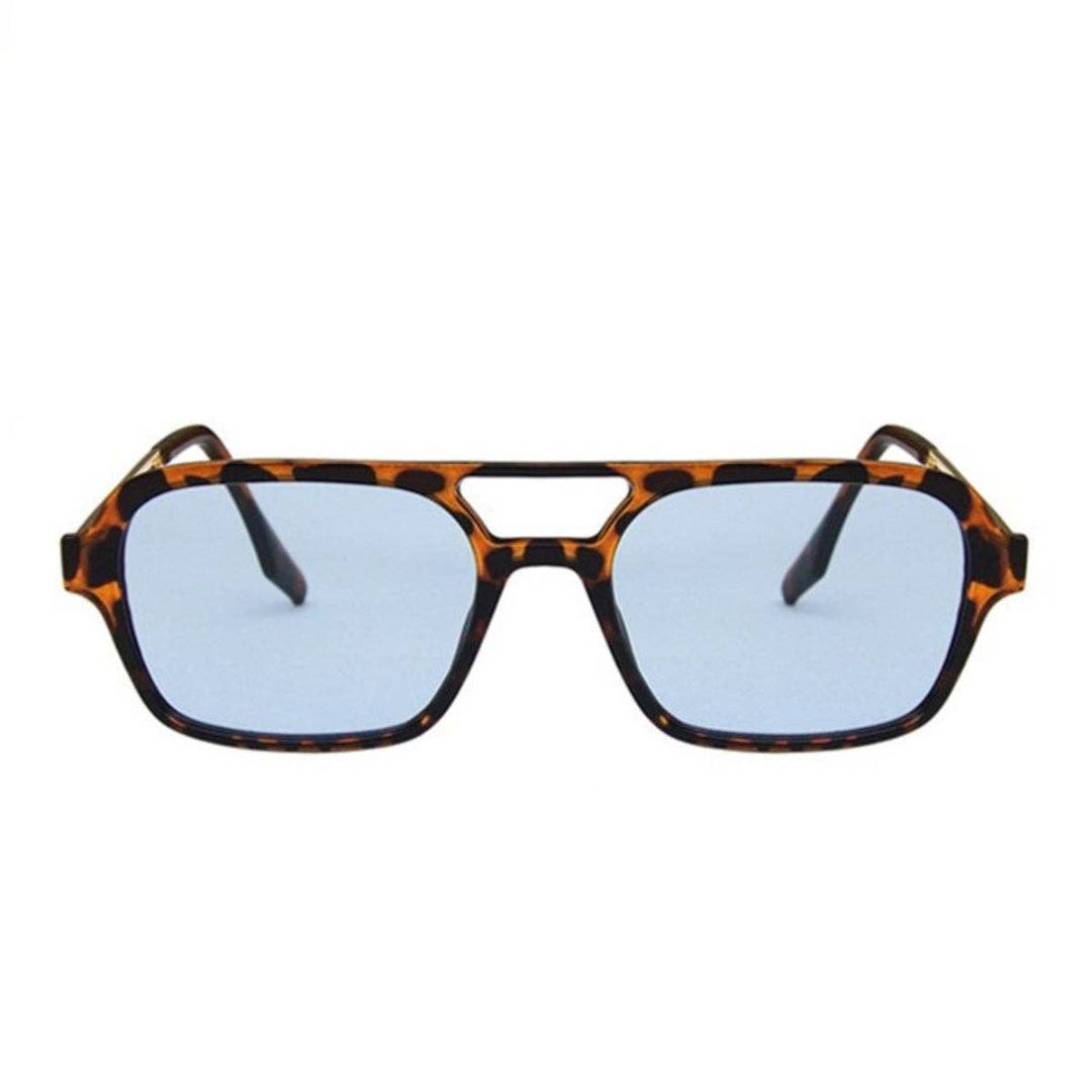 Sunglasses with tortoiseshell frame and blue lenses on a white background