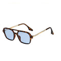 Sunglasses with tortoiseshell frame and blue lenses on a white background