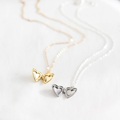 Gold and silver heart-shaped pendants on a white background