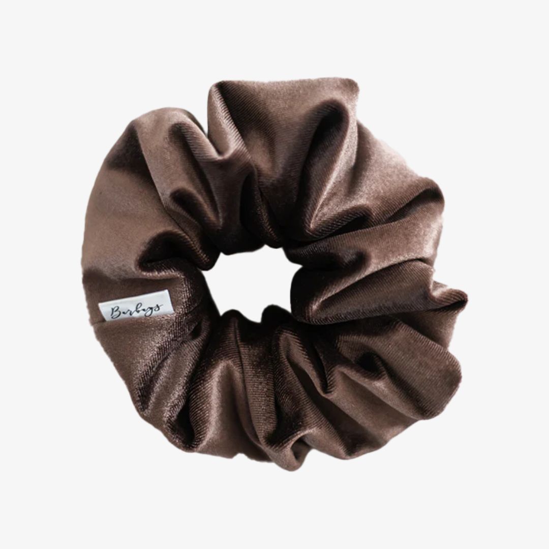 Brown scrunchie with a visible brand label on a white background