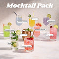 A mocktail cocktail mix pack display featuring eight labeled drinks: Cucumber Jalapeño, Lavender Lemonade, Pika Colada, Lovely Spritzer, Moscow Mule, Raspberry Lemonade, Shirley Temple, and Grapefruit Strawberry, arranged on a light surface against a textured beige wall.