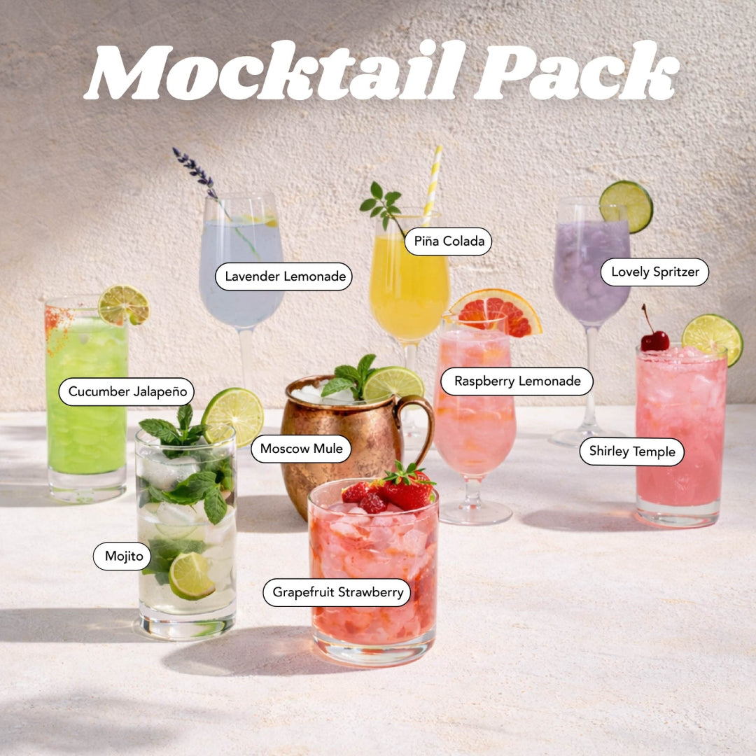A mocktail cocktail mix pack display featuring eight labeled drinks: Cucumber Jalapeño, Lavender Lemonade, Pika Colada, Lovely Spritzer, Moscow Mule, Raspberry Lemonade, Shirley Temple, and Grapefruit Strawberry, arranged on a light surface against a textured beige wall.