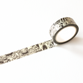 Roll of decorative tape with a black and white pattern on a white background