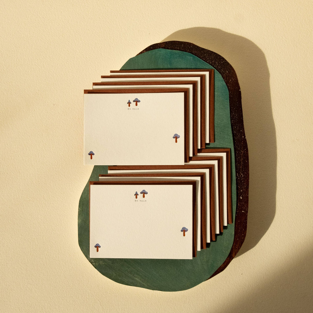 Stack of greeting cards with decorative elements on a beige background
