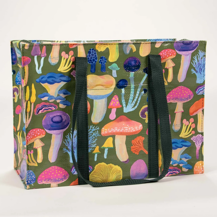 A large, reusable tote bag with a mushroom pattern. The bag is olive green with black handles. It is covered in a variety of colorful mushrooms in different shapes and sizes.