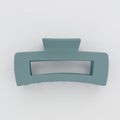 Teal hair clip on a white background