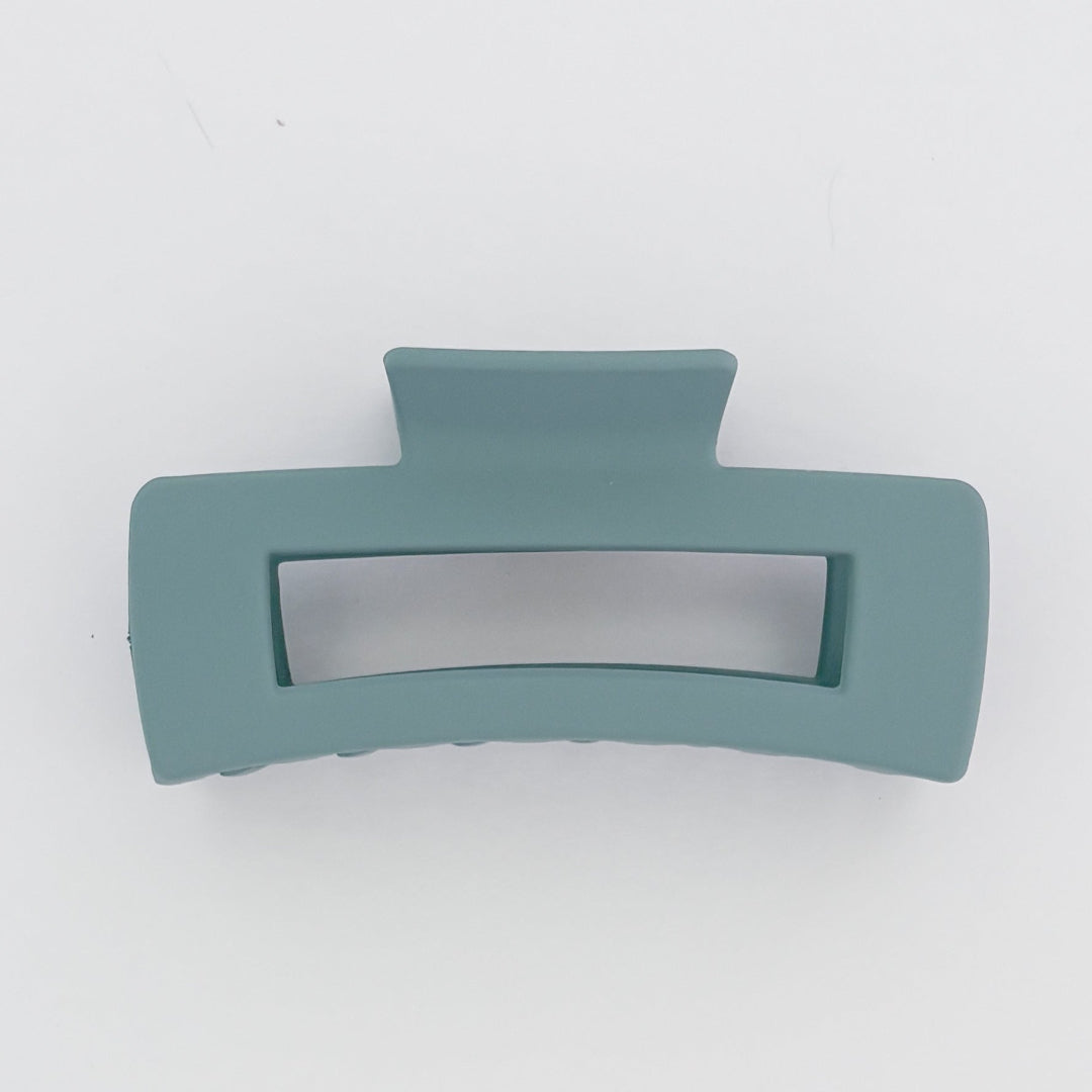 Teal hair clip on a white background