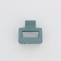 Teal hair clip on a white background