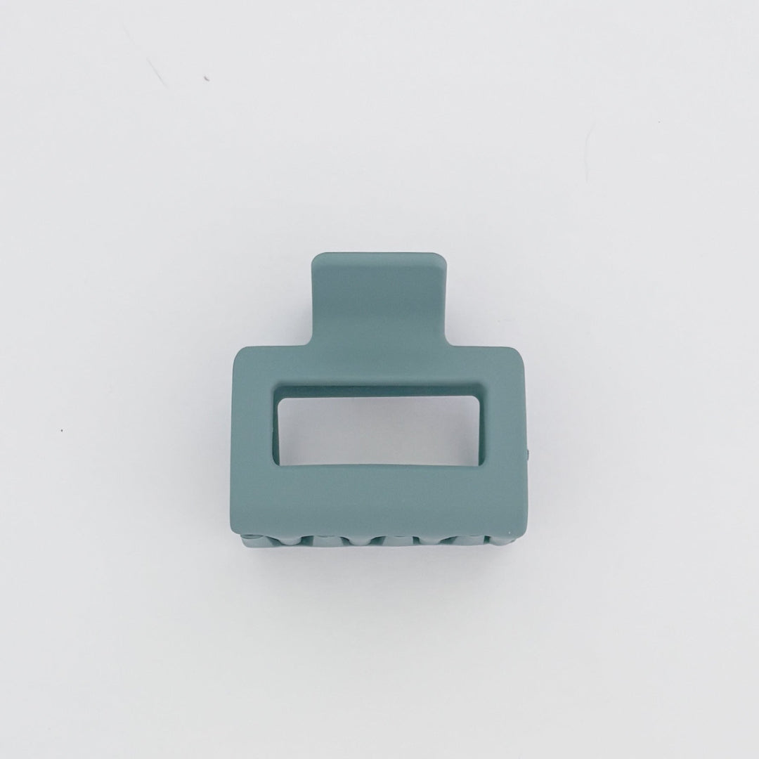 Teal hair clip on a white background