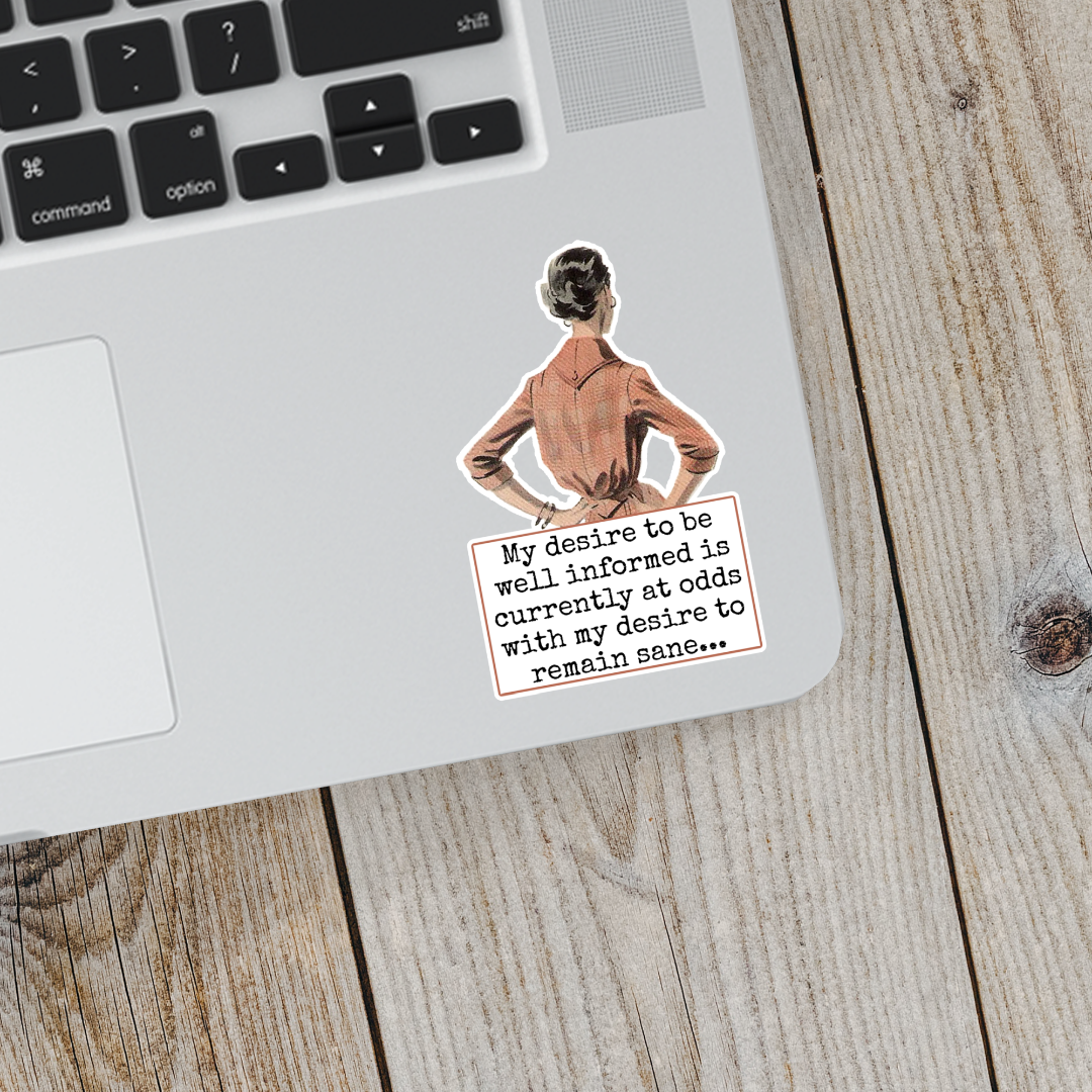 Laptop with a sticker of a person and text on a wooden surface