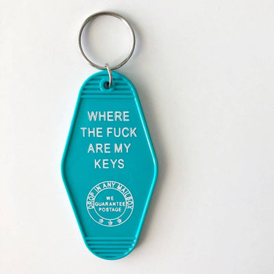 A teal, motel-style key tag with a silver keyring, featuring white text that reads 