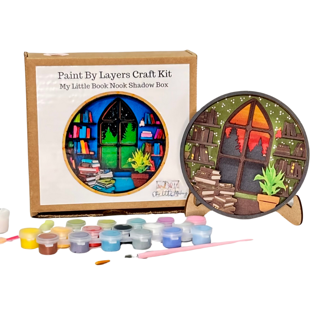 Paint by layers craft kit with a completed shadow box art and paint containers on a white background