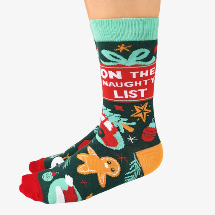 A pair of festive socks with a Christmas theme. The socks are green with red and white accents. One sock features the phrase 